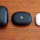 Powerbeats Pro, Beats Studio Buds, and AirPods Pro in their cases